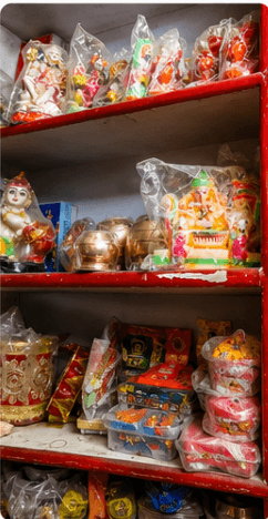 Traditional brass and clay deities of gods on shelves